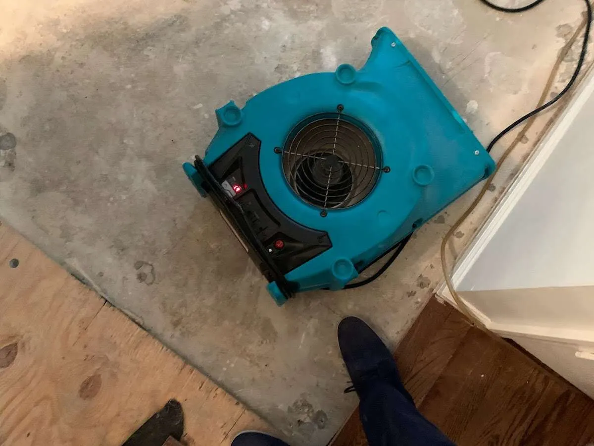 Air mover drying subfloor during Commercial Water Damage Restoration in Purcell